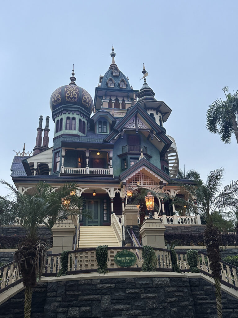 a large house with a balcony and palm trees