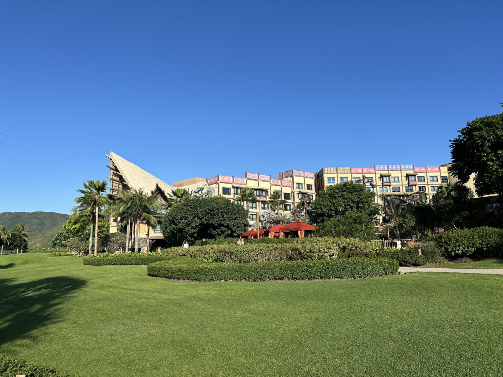 a large building with a lawn and trees