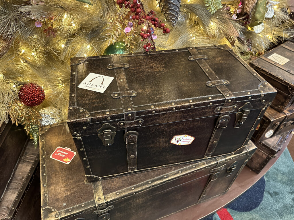 two boxes with metal straps and a christmas tree