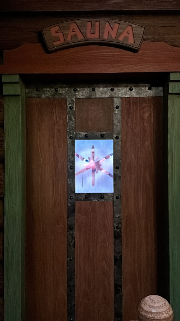 a wooden door with a glass panel with a face on it