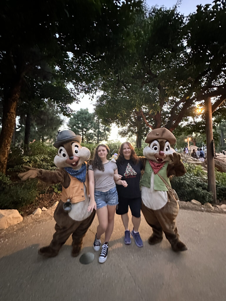 a group of people posing for a picture with a group of people in clothing
