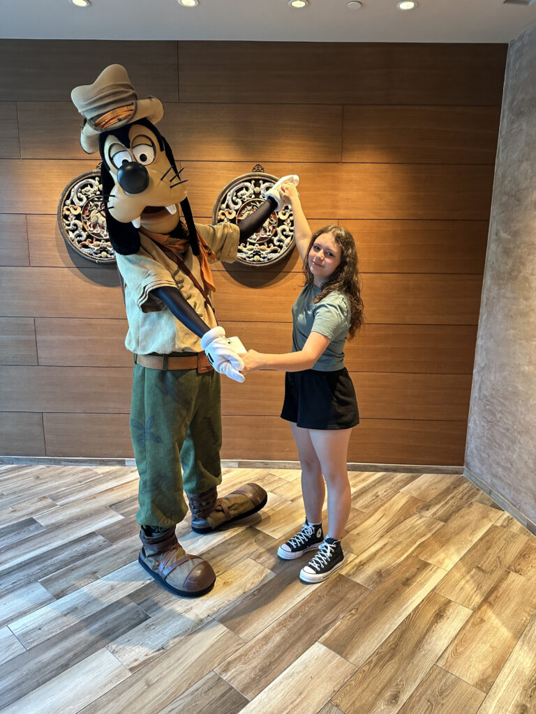 a woman holding hands with a cartoon character
