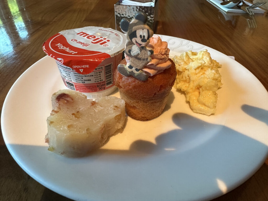 a plate of food with a cartoon character on top