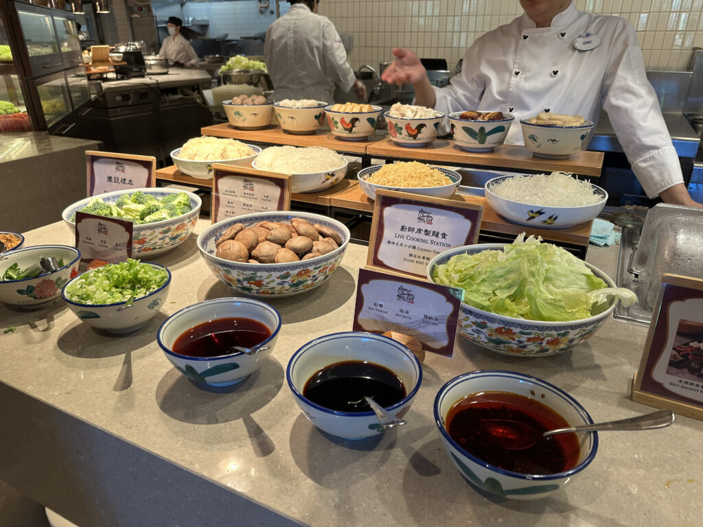 a chef in a kitchen with bowls of food