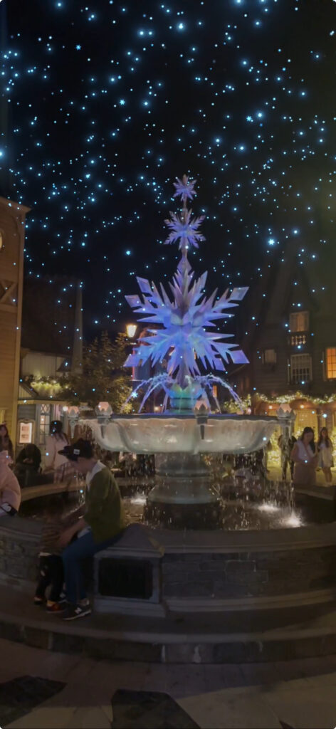 a fountain with a large snowflake in the middle