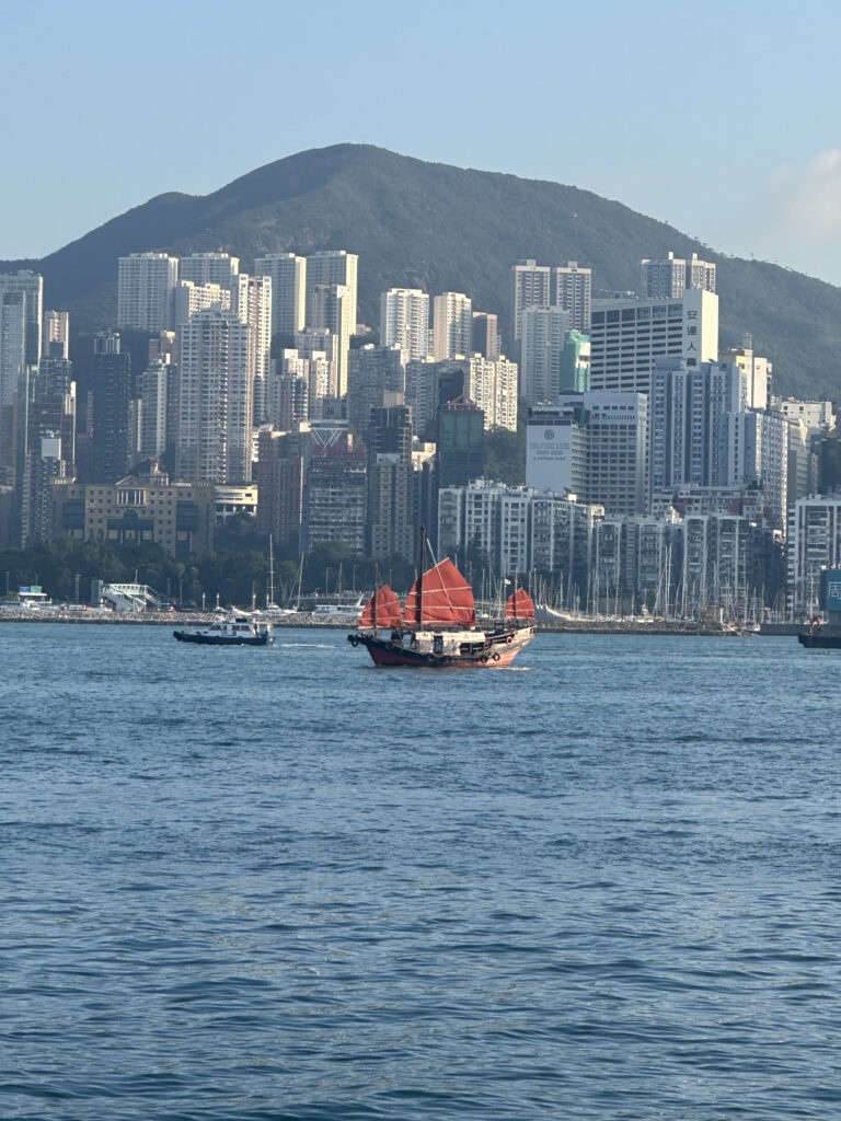 a boat in the water with a city in the background