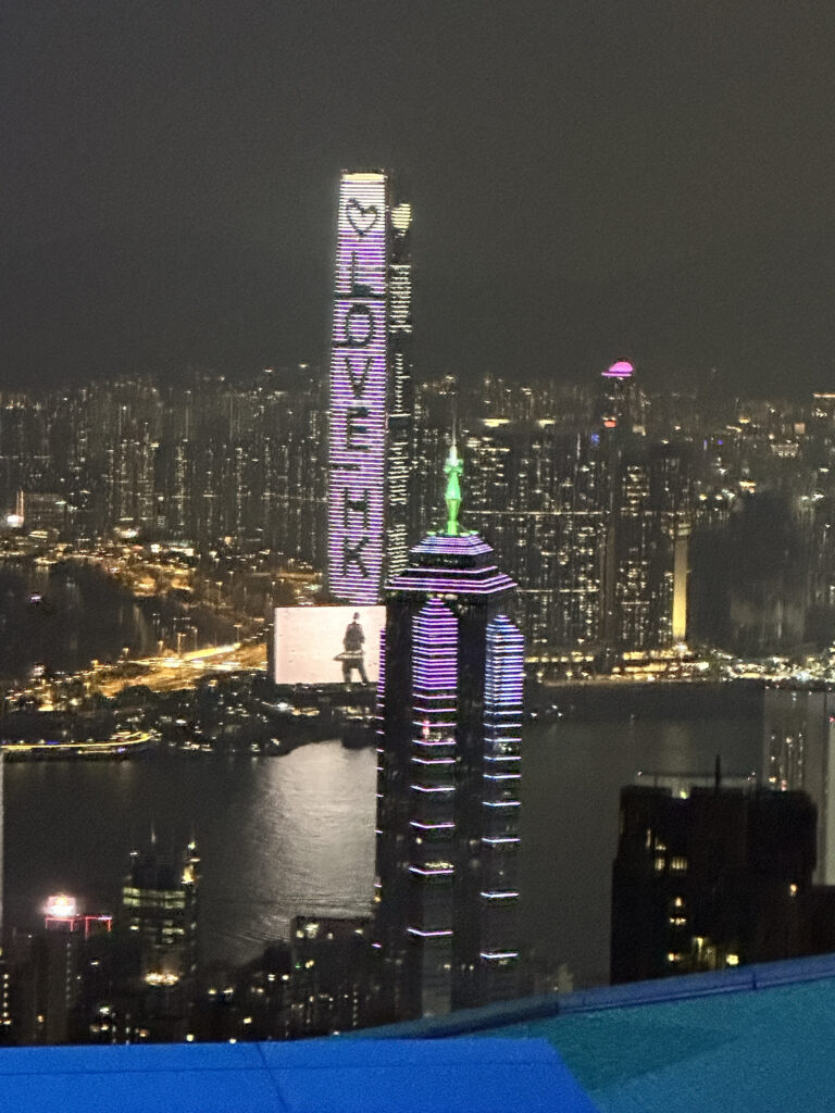 a city skyline with tall buildings and a large body of water