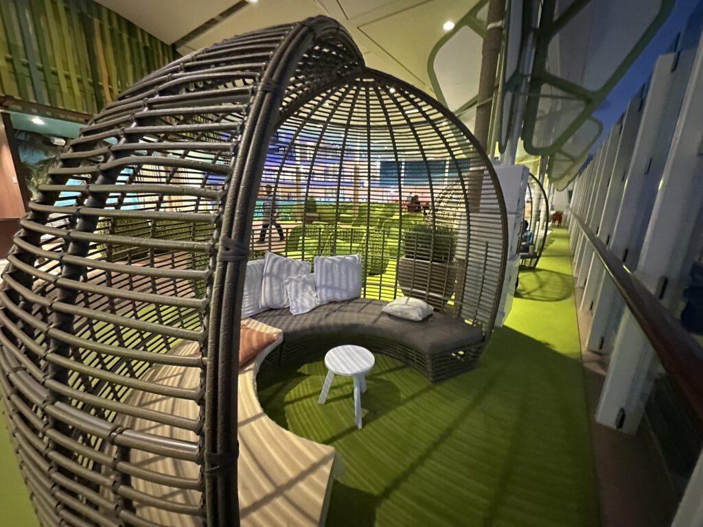 a round wicker chair with a round table and a round bench