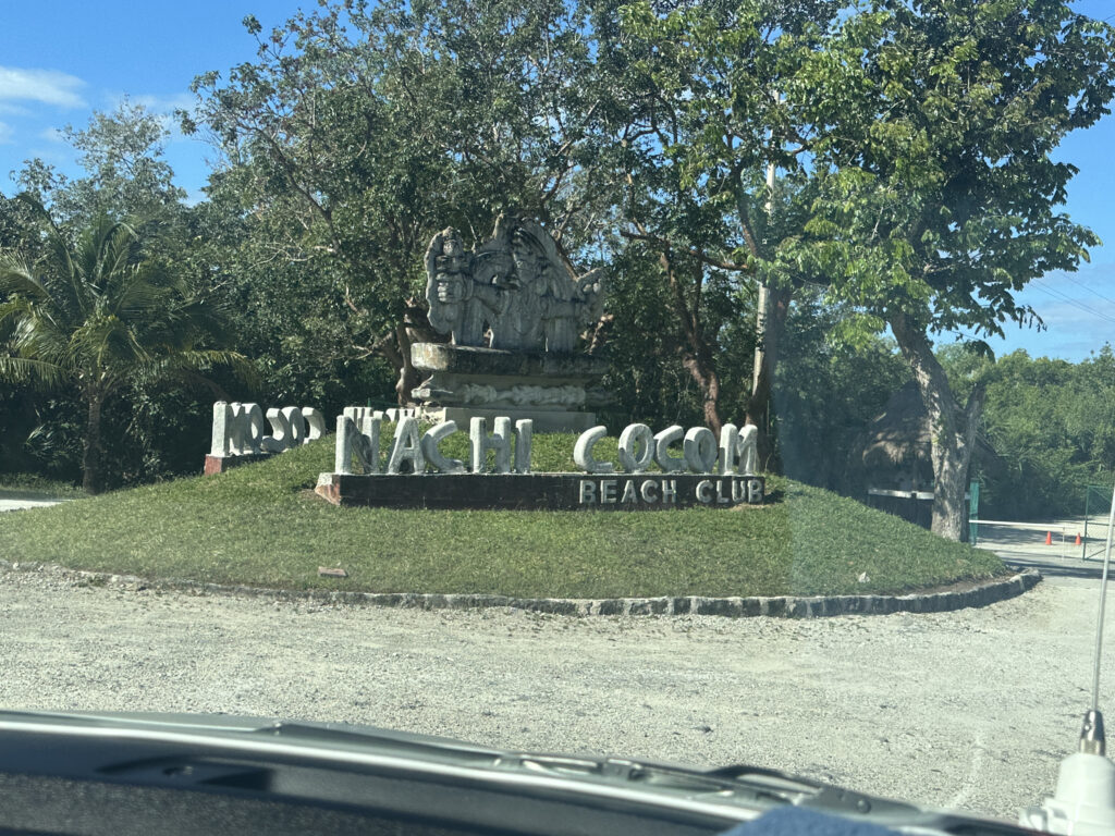 a sign on a grassy area