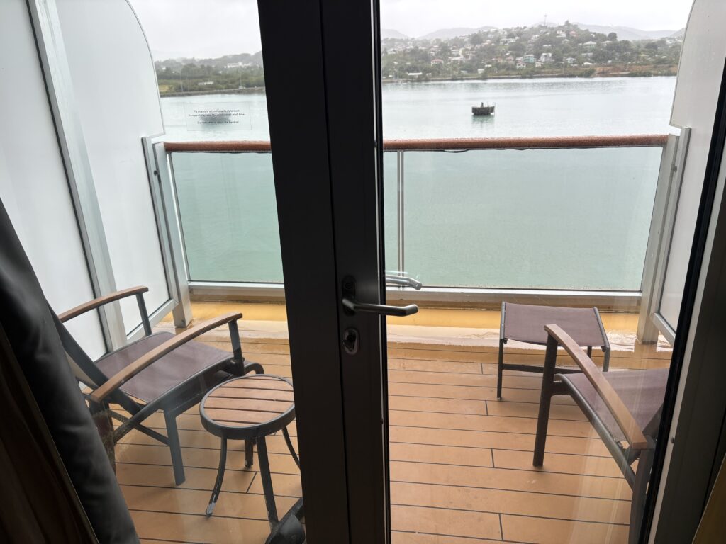 a balcony with chairs and a glass door
