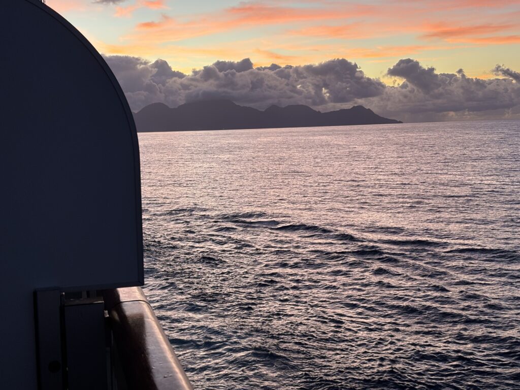 a body of water with mountains in the distance