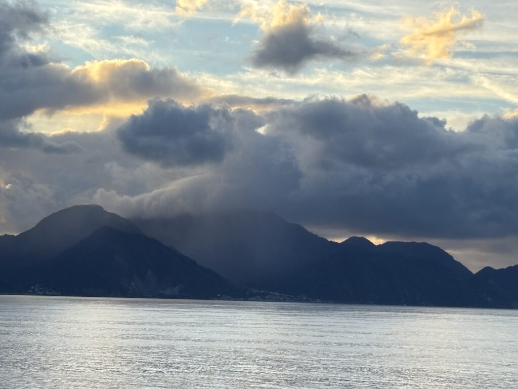a body of water with mountains in the distance