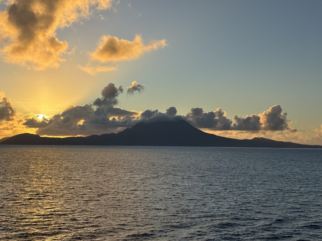 a body of water with a mountain in the distance