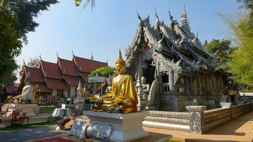 a statue of a buddha in front of a temple