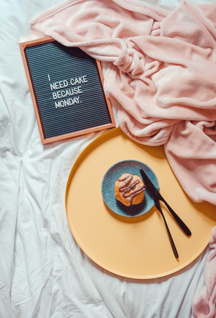 a plate with a pastry on it next to a sign