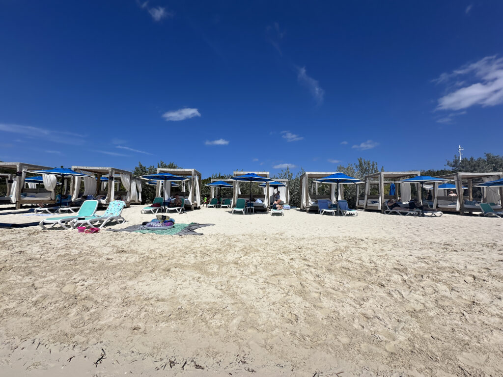 a beach with chairs and umbrellas