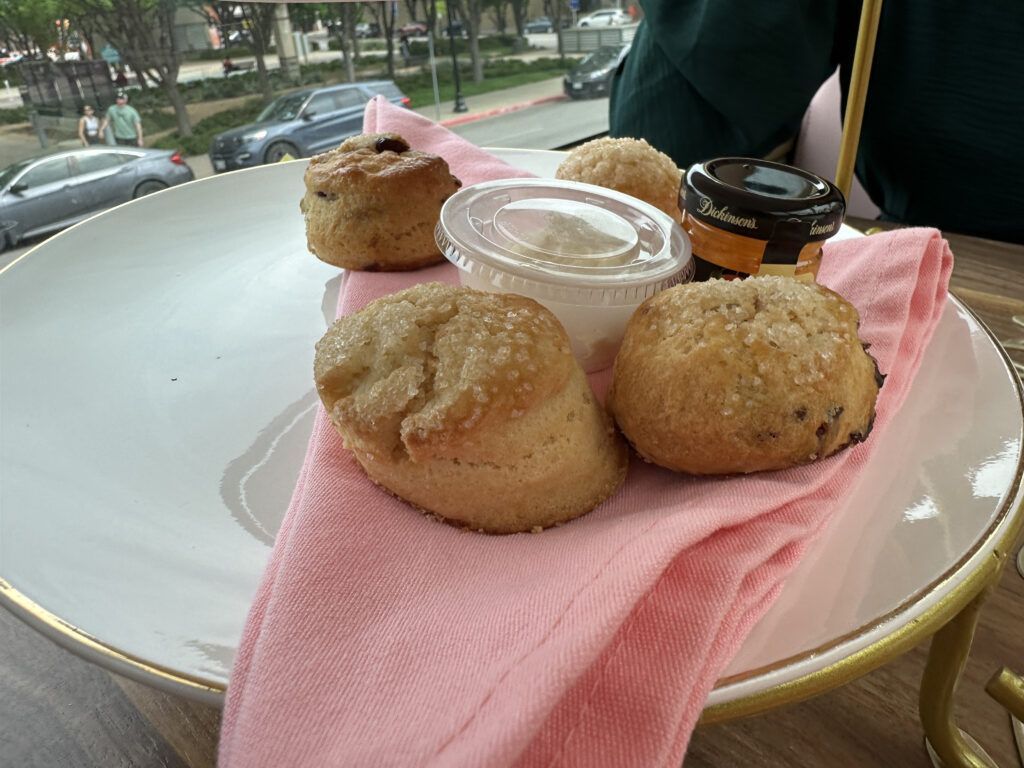 a plate of muffins and a jar of jam