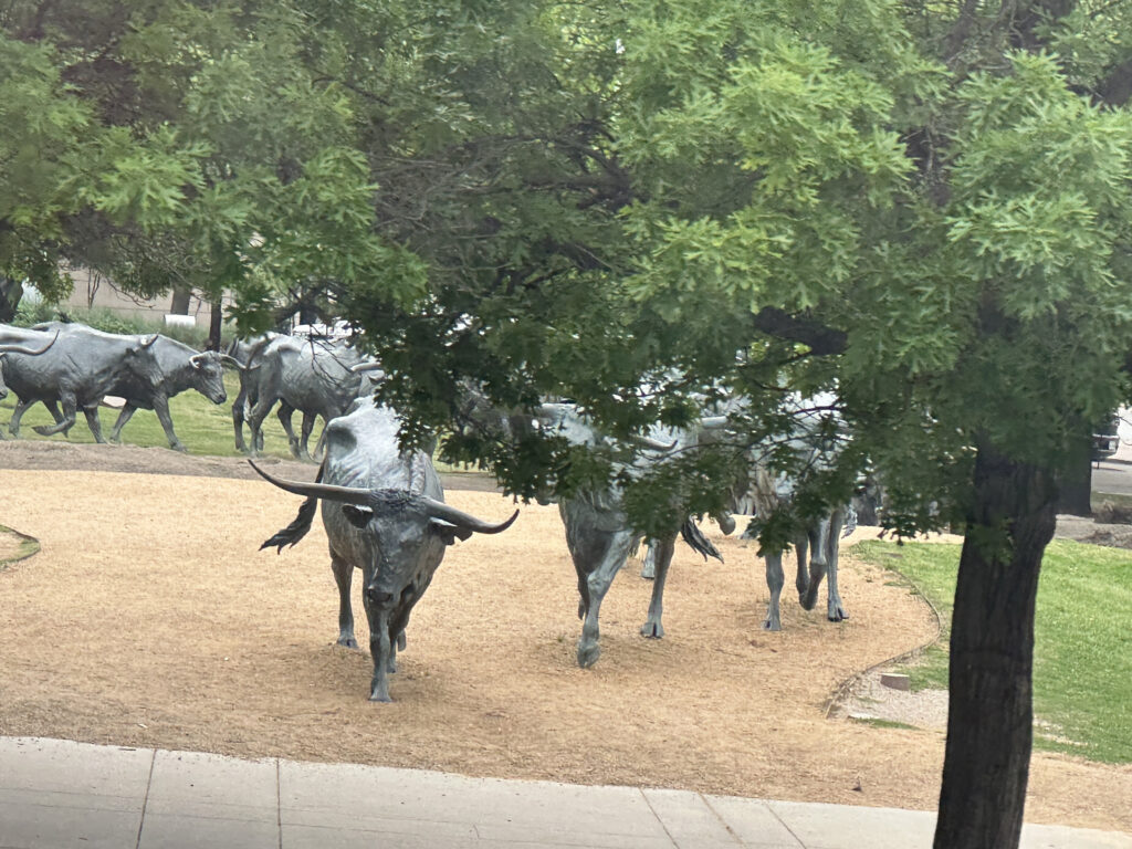 a group of bull statues in a park