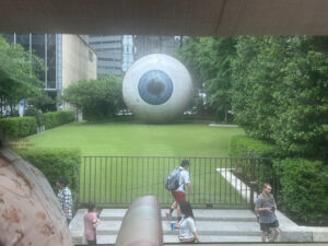 a large eyeball sculpture in a grassy area