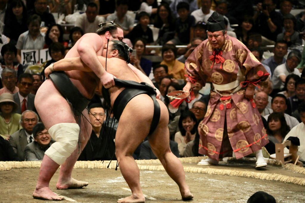 two men wrestling in a wrestling ring