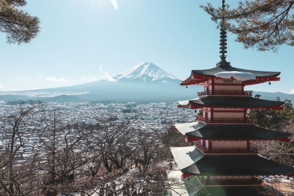 a pagoda with Mount Fuji in the background