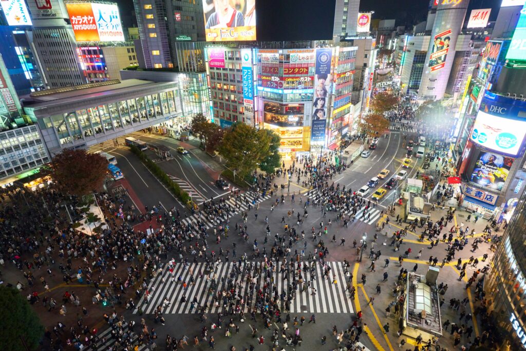 a crowd of people crossing a street