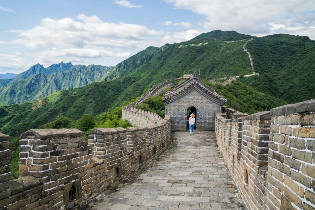 a person walking on a stone wall