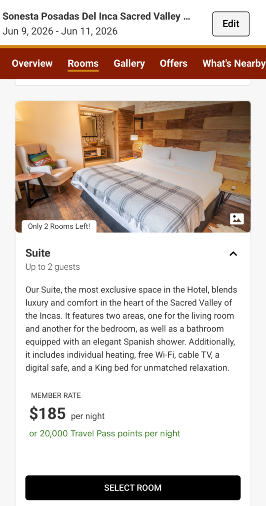 The image shows a hotel booking page for Sonesta Posadas Del Inca Sacred Valley. It displays a suite room with a large bed covered with a plaid blanket, a cushioned chair with colorful pillows, and a small side table. The room has wooden accents and a view into a bathroom with a patterned wall. The text indicates the suite accommodates up to two guests and includes amenities like individual heating, free Wi-Fi, cable TV, a digital safe, and a King bed. The member rate is $185 per night or 20,000 Travel Pass points. There is a "Select Room" button at the bottom.