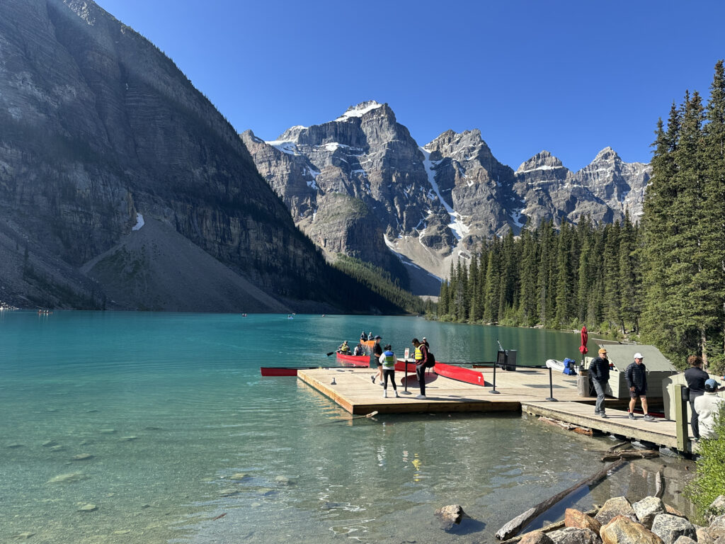 a group of people on a dock on a lake
