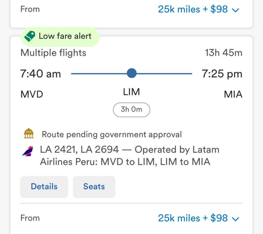 The image is a screenshot of a flight booking page from Alaska Airlines. It shows two flight options with a "Low fare alert" label. 1. The first option is a multiple-flight itinerary from MVD (Montevideo) to MIA (Miami) with a stop at GRU (São Paulo). The total travel time is 13 hours and 15 minutes, arriving the next day. The flights are operated by LATAM Airlines. 2. The second option is a multiple-flight itinerary from MVD to MIA with a stop at LIM (Lima). The total travel time is 13 hours and 45 minutes. The route is pending government approval and is operated by Latam Airlines Peru. Both options are priced at 25,000 miles plus $98. There are buttons for "Details" and "Seats" for each option. The page also shows the Alaska Airlines logo and a "oneworld" logo at the top.