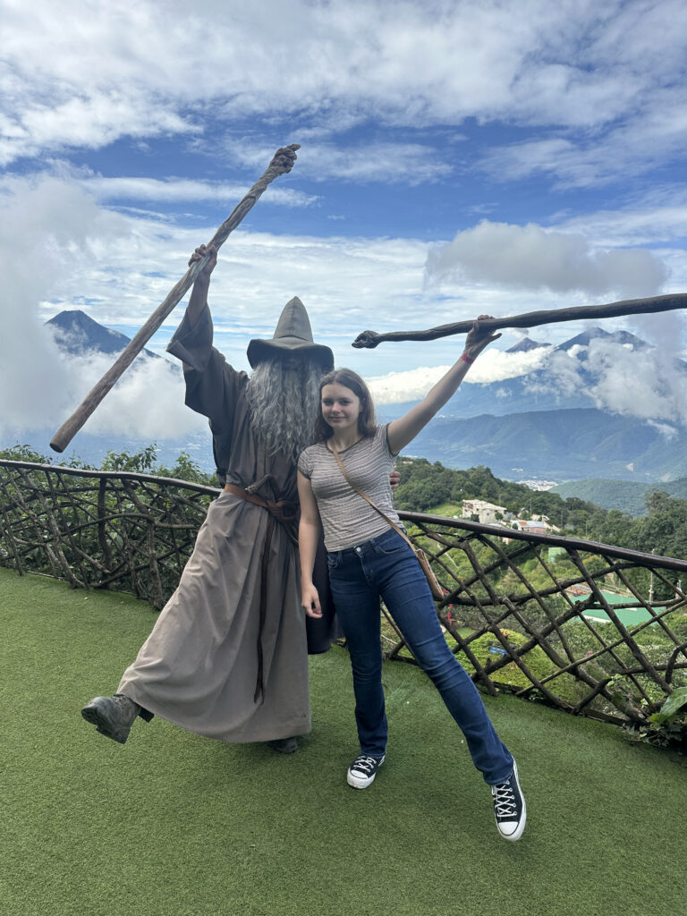 a woman standing next to a person in a garment